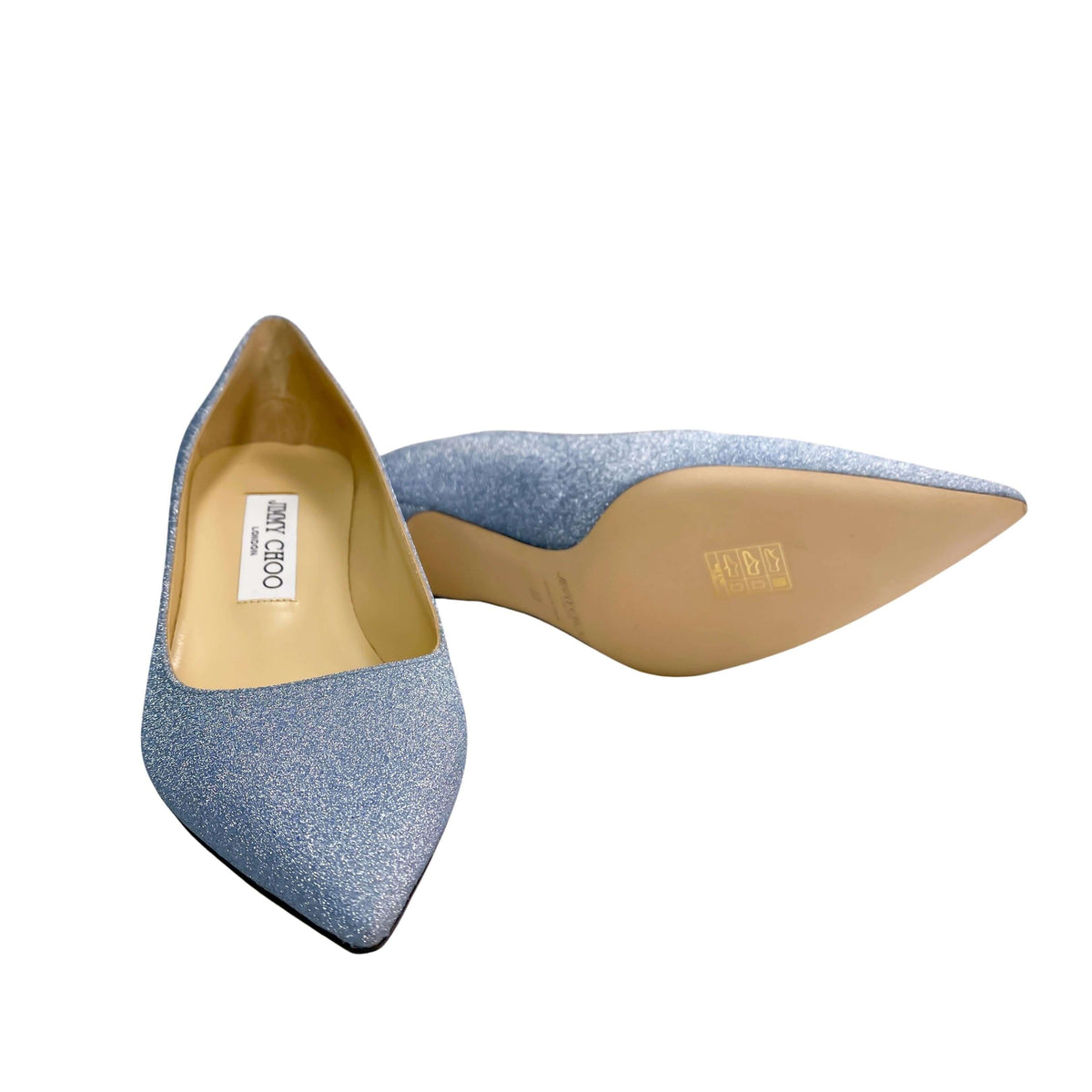 Close-up detail view of the gold Jimmy Choo London branded insole and interior leather lining of the light blue Aza 50 pump.