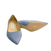 Close-up detail view of the gold Jimmy Choo London branded insole and interior leather lining of the light blue Aza 50 pump.