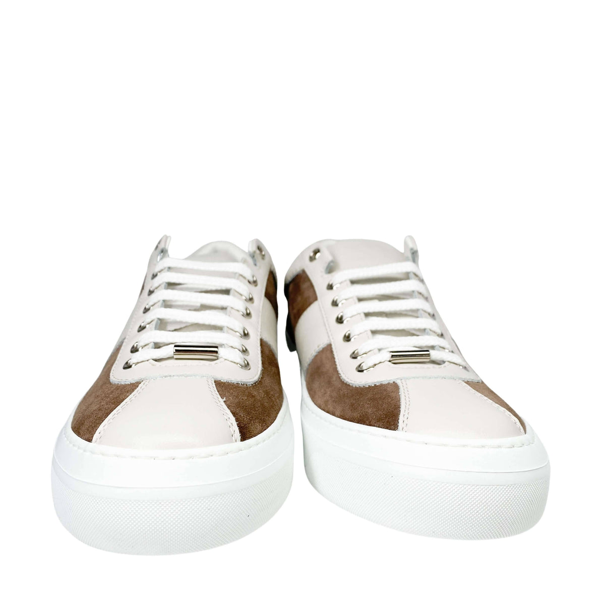 Front view of a pair of Jimmy Choo Portman white leather and brown suede sneakers showing white laces.