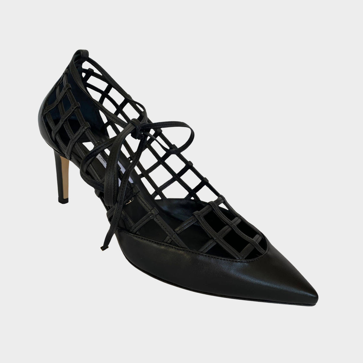 Side profile of Jimmy Choo Soraya 65 cage pumps in black leather featuring a latticed cutout design, pointed toe, and 65mm mid heel.