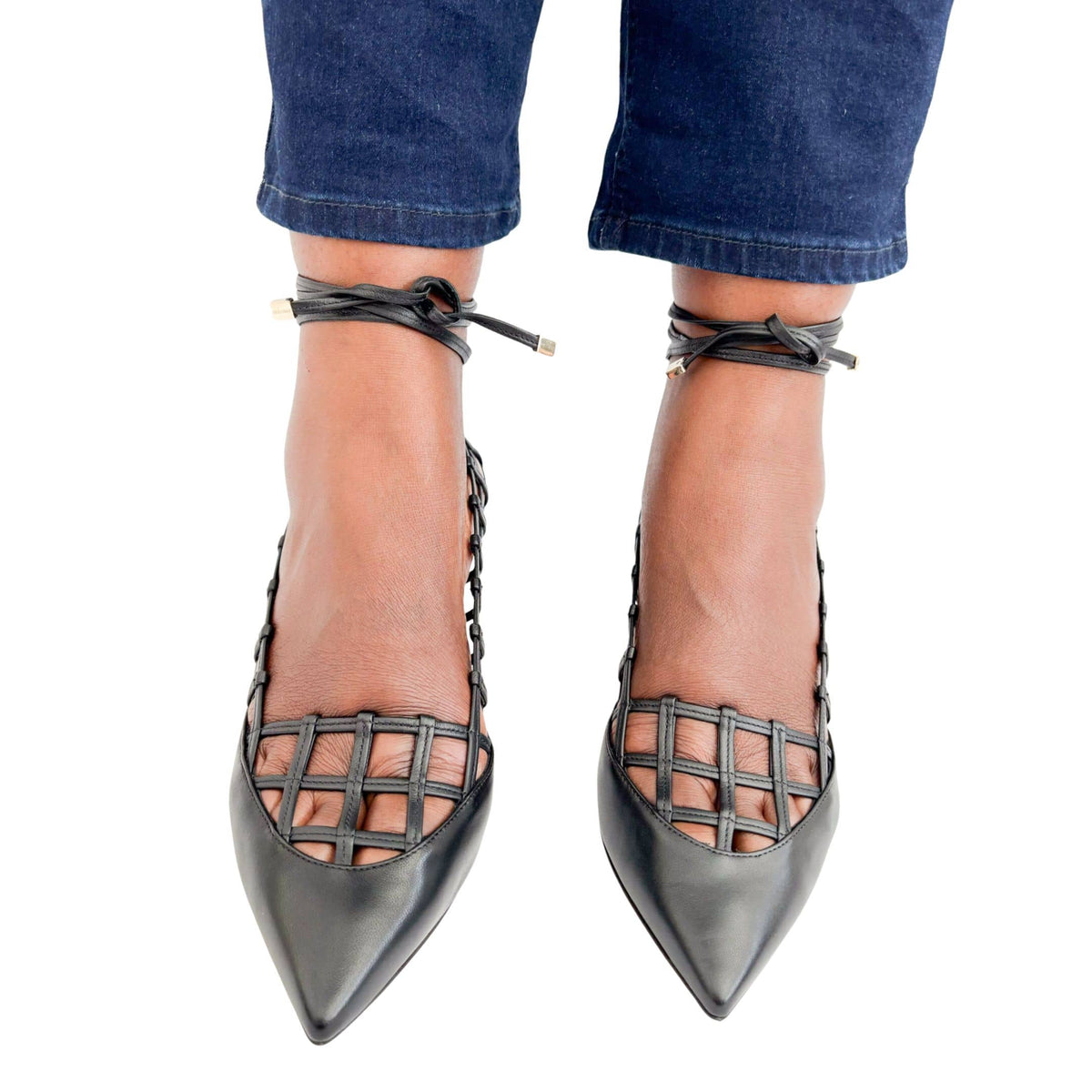 Direct front view on foot of Jimmy Choo Soraya 65 black caged pumps highlighting the sleek pointed toe box and wrap-around straps.
