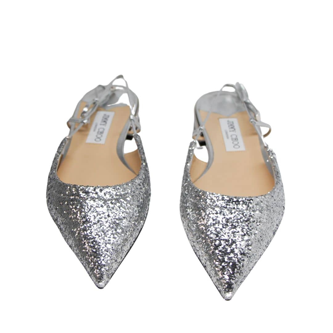 Direct front pair view of Jimmy Choo Gemista silver glitter pointed-toe flats displayed on a clean studio background.