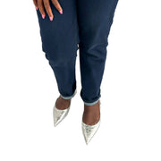 Front perspective view of Jimmy Choo Gemista silver glitter slingback flats styled on foot with dark wash denim jeans.