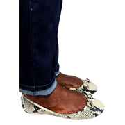 On-foot view of Jimmy Choo Walsh snake-embossed ballerina flats styled with casual denim jeans.