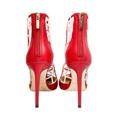Rear view highlighting the back zip entry and 100mm stiletto heel design on the Jimmy Choo Sheldon red leather pumps.