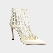Side profile of Jimmy Choo Sheldon 100 cage pumps in white leather featuring a sculptural lattice design, pointed toe, and 100mm stiletto heel.