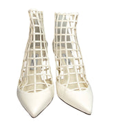 Direct front view of a pair of Jimmy Choo Sheldon 100 white leather lattice bridal heels showing the sharp pointed toe box.