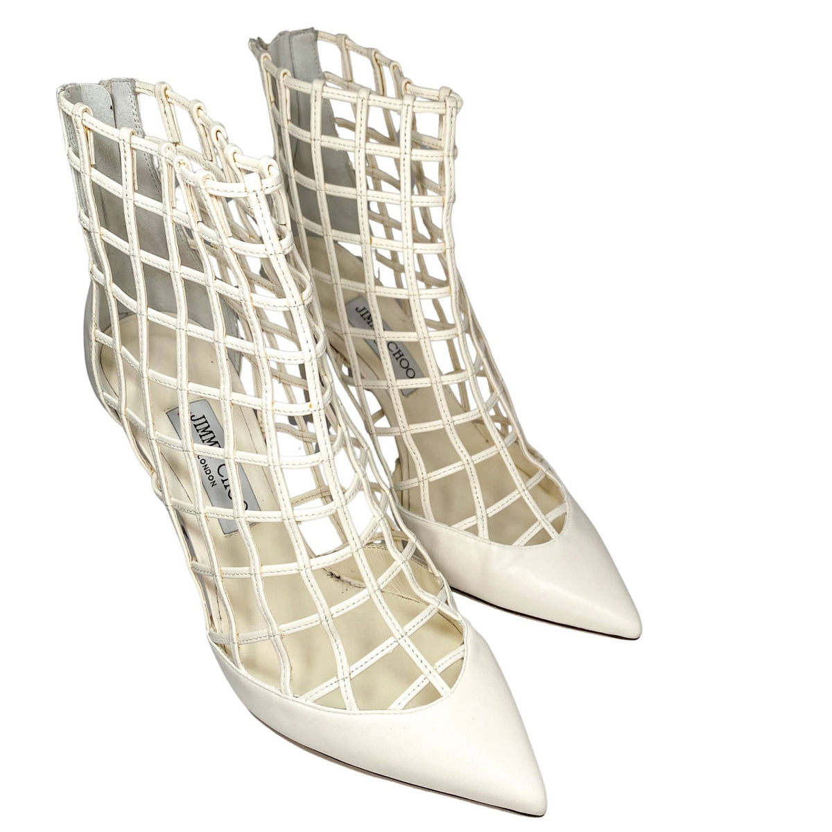 Three-quarter view of Jimmy Choo Sheldon 100 white leather caged bootie pumps on a clean studio background.