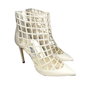 Side profile view highlighting the intricate laser-cut white leather lattice structure and sleek silhouette of the Jimmy Choo Sheldon 100 heel.