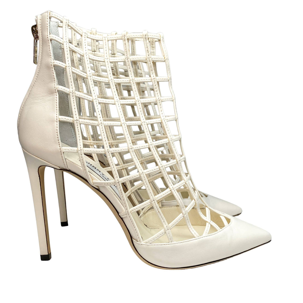 Pair perspective of Jimmy Choo Sheldon 100 white leather cutout stiletto boots displayed together.