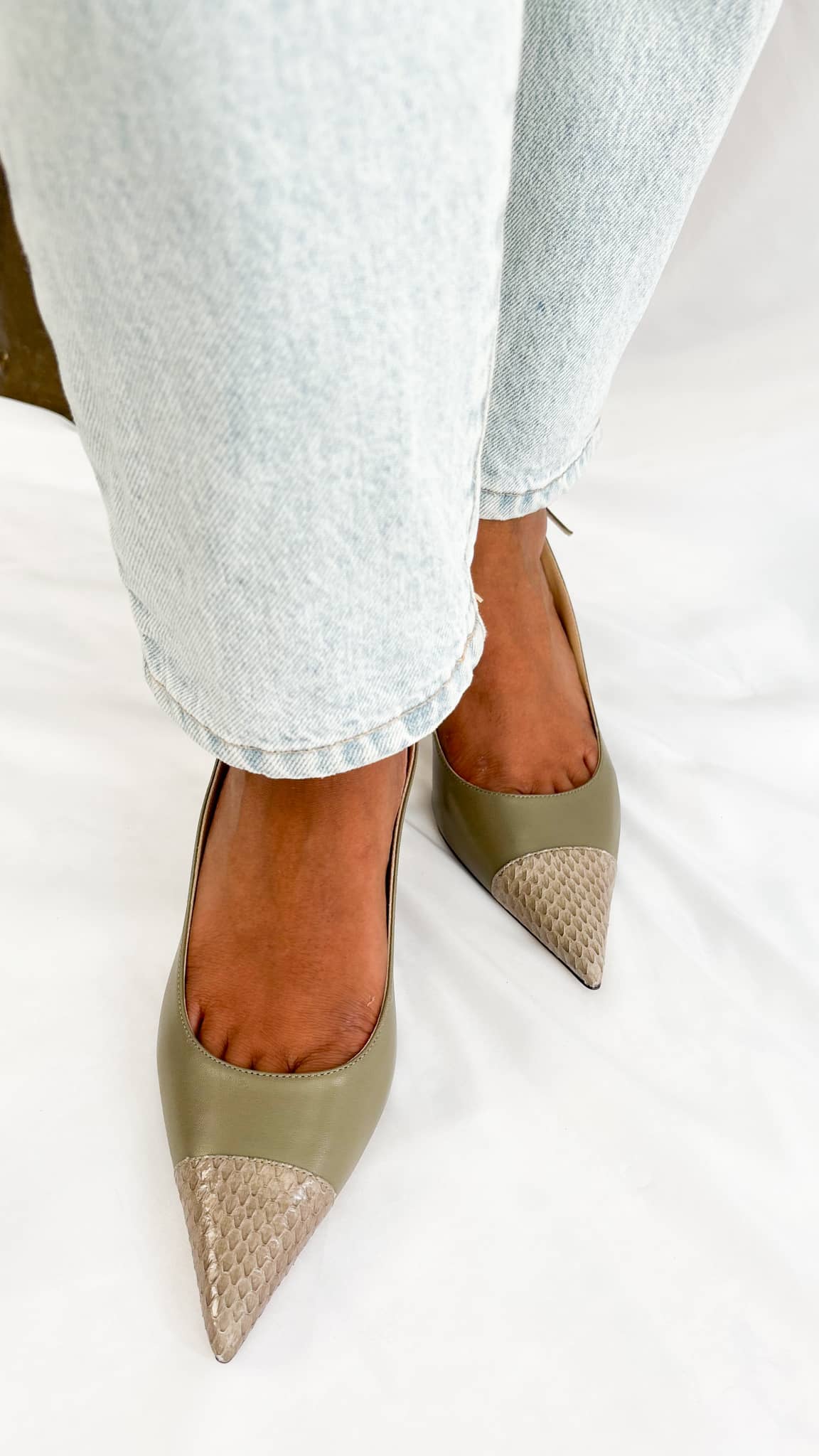 A direct glance focusing on the wearer’s ankles from behind, showing how the slim slingback strap of the Anika 65 provides a secure, low-profile fit.