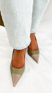 A direct glance focusing on the wearer’s ankles from behind, showing how the slim slingback strap of the Anika 65 provides a secure, low-profile fit.