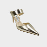 Side angle view of Jimmy Choo Cheri 85 pointed-toe pumps in metallic gold leather with high ankle cuff strap.