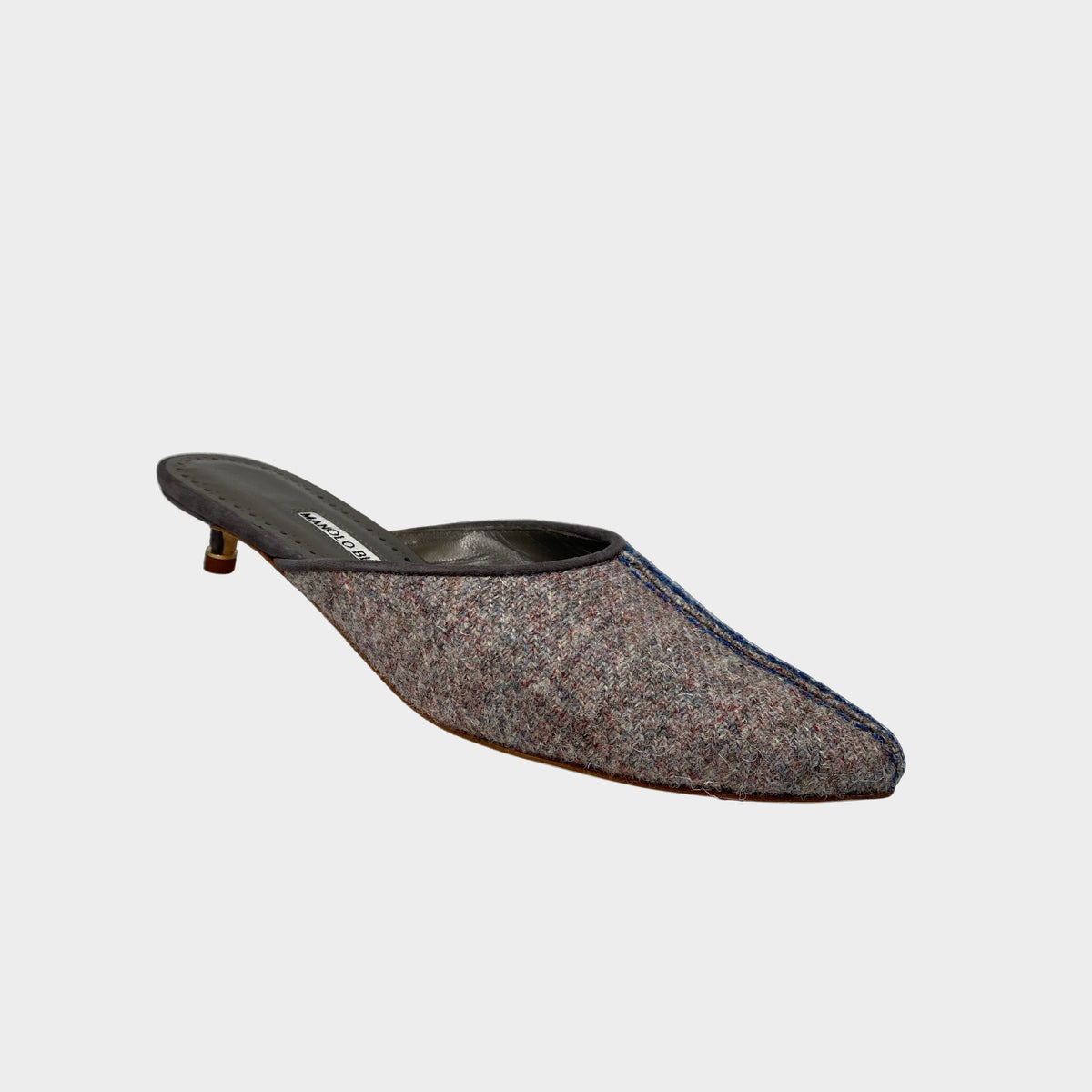 Side profile view of Manolo Blahnik Ajita 30 felt mules in dark blue and grey wool featuring front stitch detail and a 30mm grey suede kitten heel.