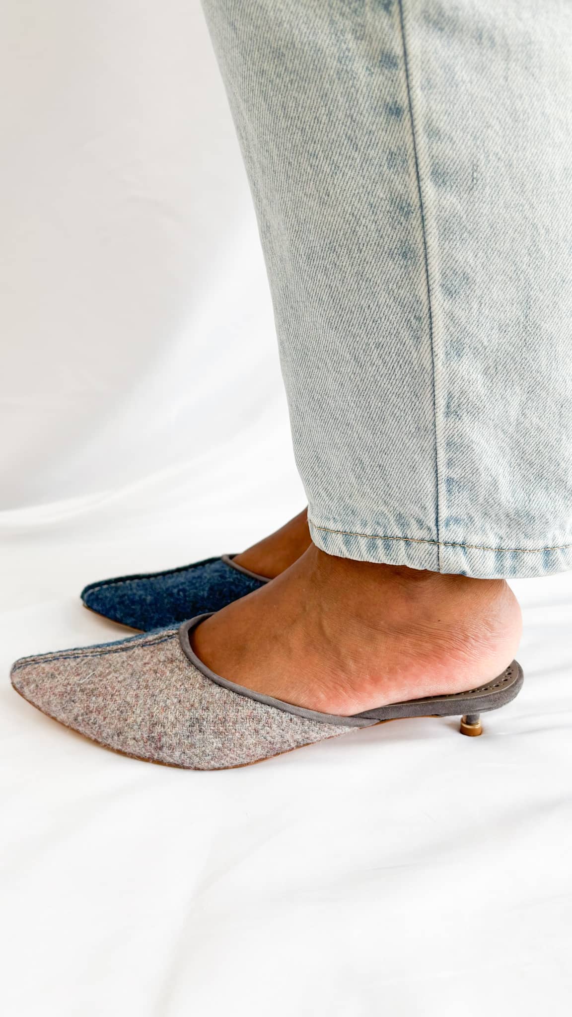Side profile view on foot showcasing the low 30mm suede kitten heel and soft wool felt upper of the Manolo Blahnik Ajita mule.