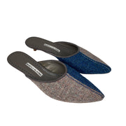 Three-quarter studio view of a pair of Manolo Blahnik Ajita 30 dark blue and grey wool felt mules.
