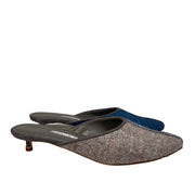Side profile studio shot of the Manolo Blahnik Ajita 30 mule showcasing the two-tone dark blue and grey wool felt construction.