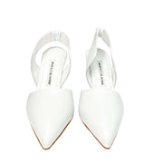Top-down studio view of a pair of Manolo Blahnik Meana white leather heels highlighting the elegant pointed toe box.