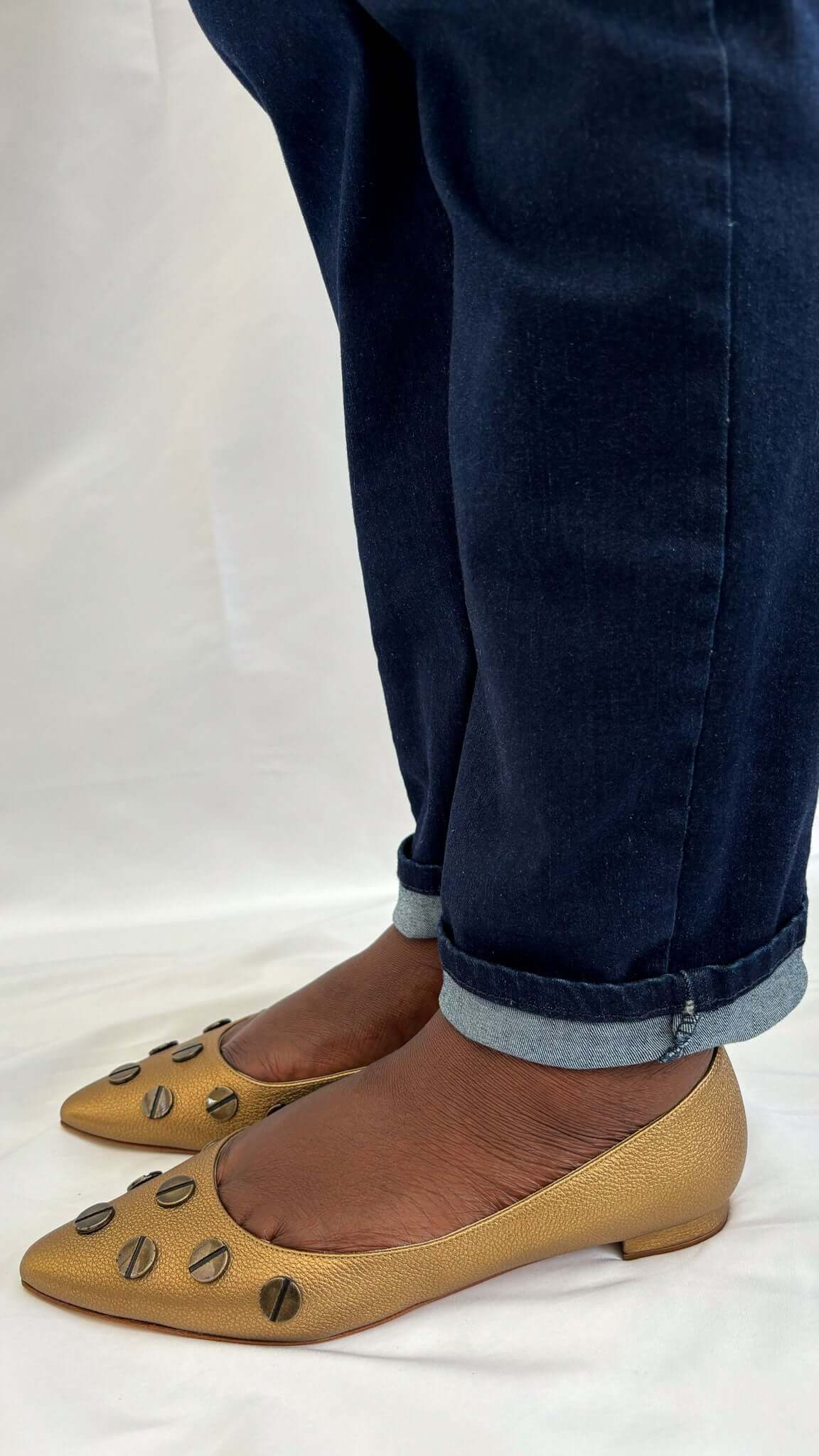 Profile view of a Manolo Blahnik Panunzia bronze leather flat shoe on-foot showing low 10mm heel profile.