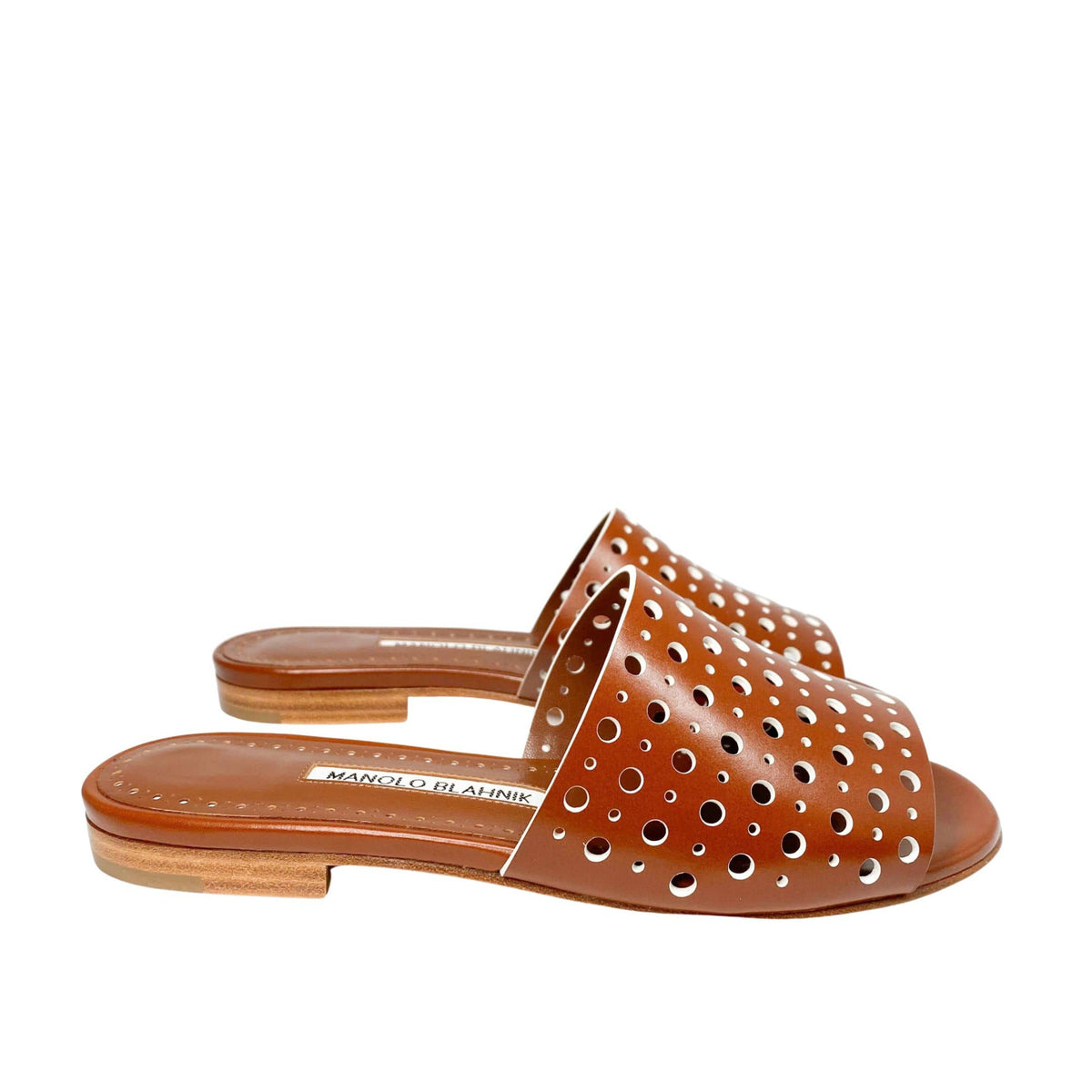 Studio side profile of Manolo Blahnik Prepona brown leather flat sandal showcasing the low heel and structured perforated vamp.