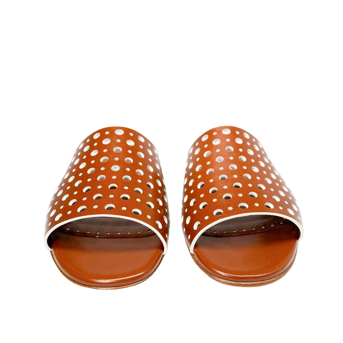 Direct front view of a pair of Manolo Blahnik Prepona brown leather open-toe slide sandals showing the laser-cut perforated pattern.