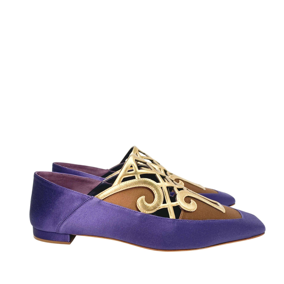 Pair of Manolo Blahnik Abukov flats showing the distinct square toe box and intricate gold metallic details.