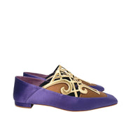 Pair of Manolo Blahnik Abukov flats showing the distinct square toe box and intricate gold metallic details.