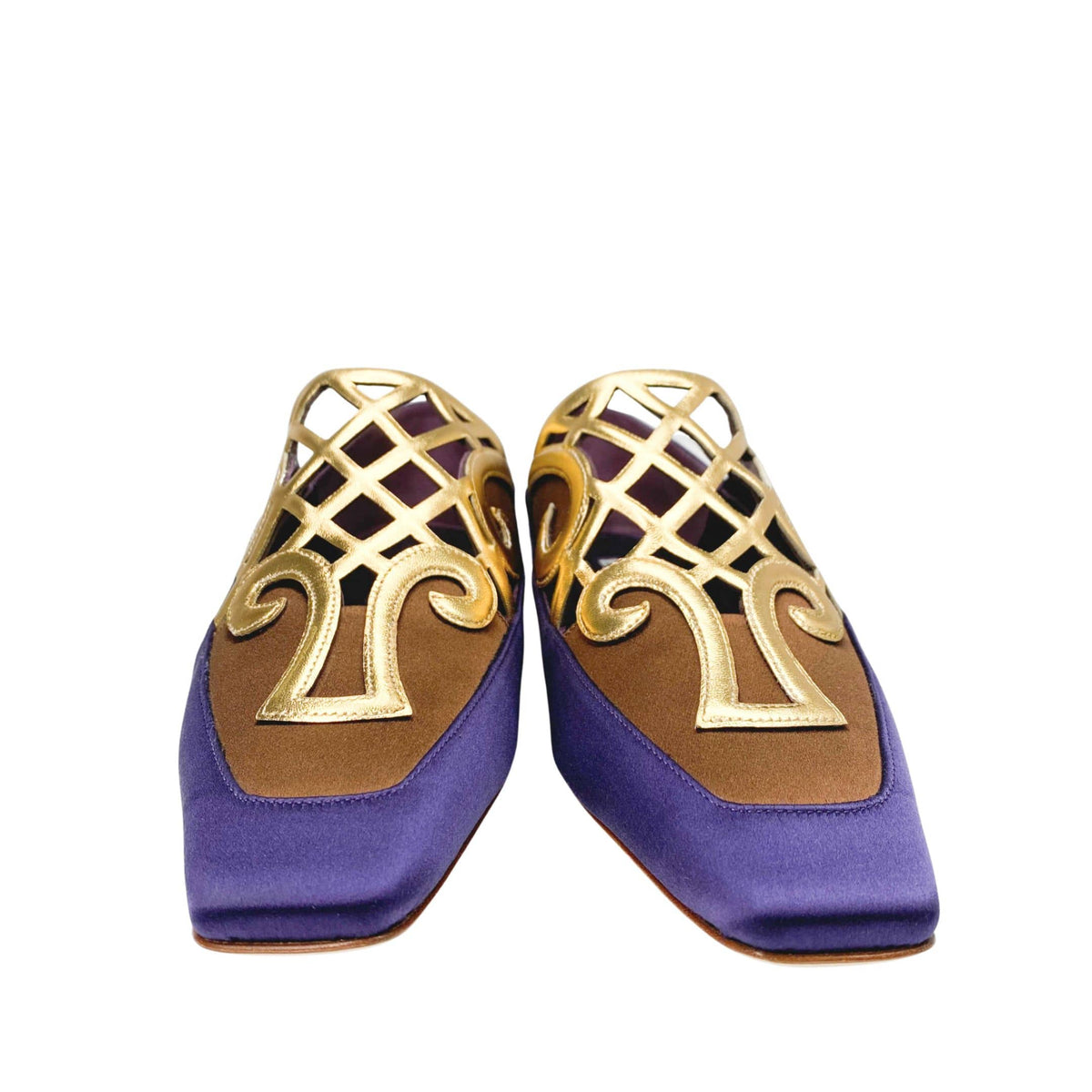 Pair of Manolo Blahnik Abukov flats showing the distinct square toe box and intricate gold metallic details.
