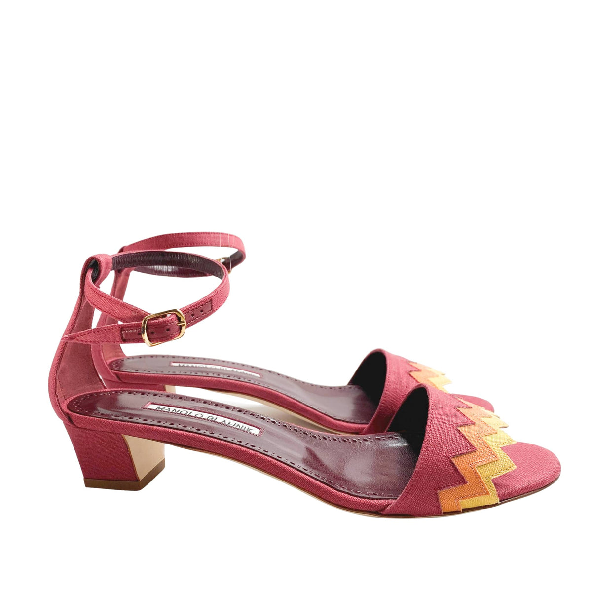 Studio side perspective of a single Manolo Blahnik Lochpri red canvas sandal highlighting the low block-style kitten heel and open toe.