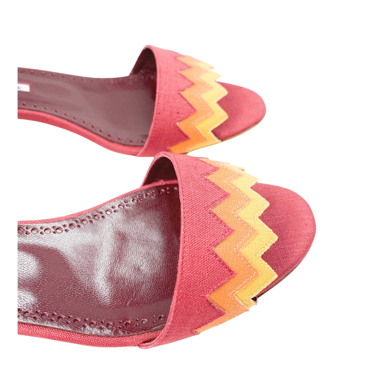 Close-up front view of the multi-colored zig-zag pattern canvas vamp and leather footbed on Manolo Blahnik Lochpri sandals.