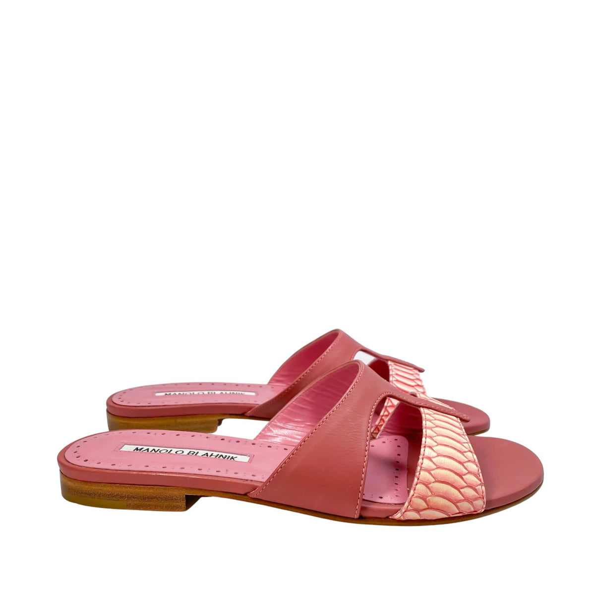 Studio side profile of the Manolo Blahnik Popilla flat pink sandal showcasing the flat leather sole and wide cutout vamp design.