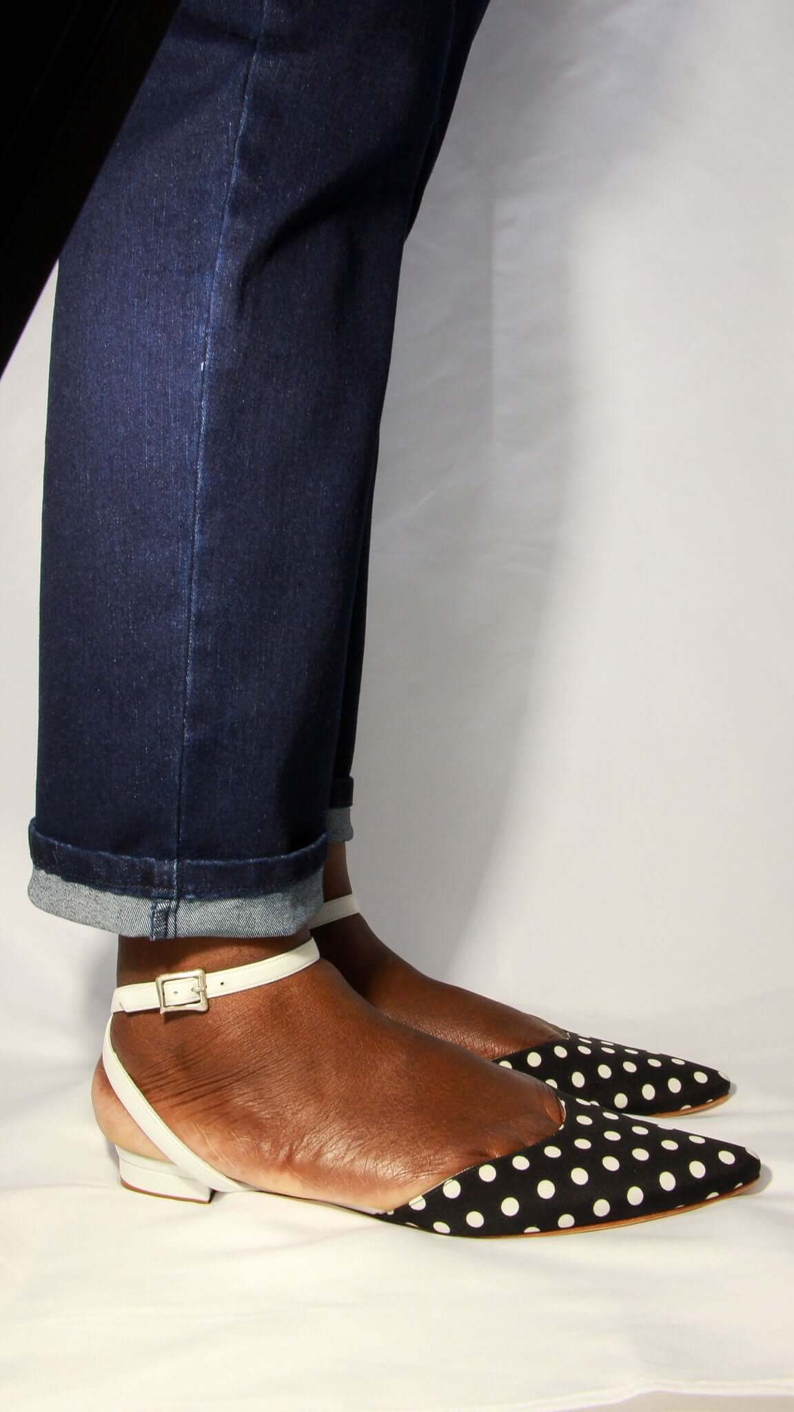 Side profile view of the Manolo Blahnik Asensoflat polka dot shoe showing the adjustable leather ankle strap.
