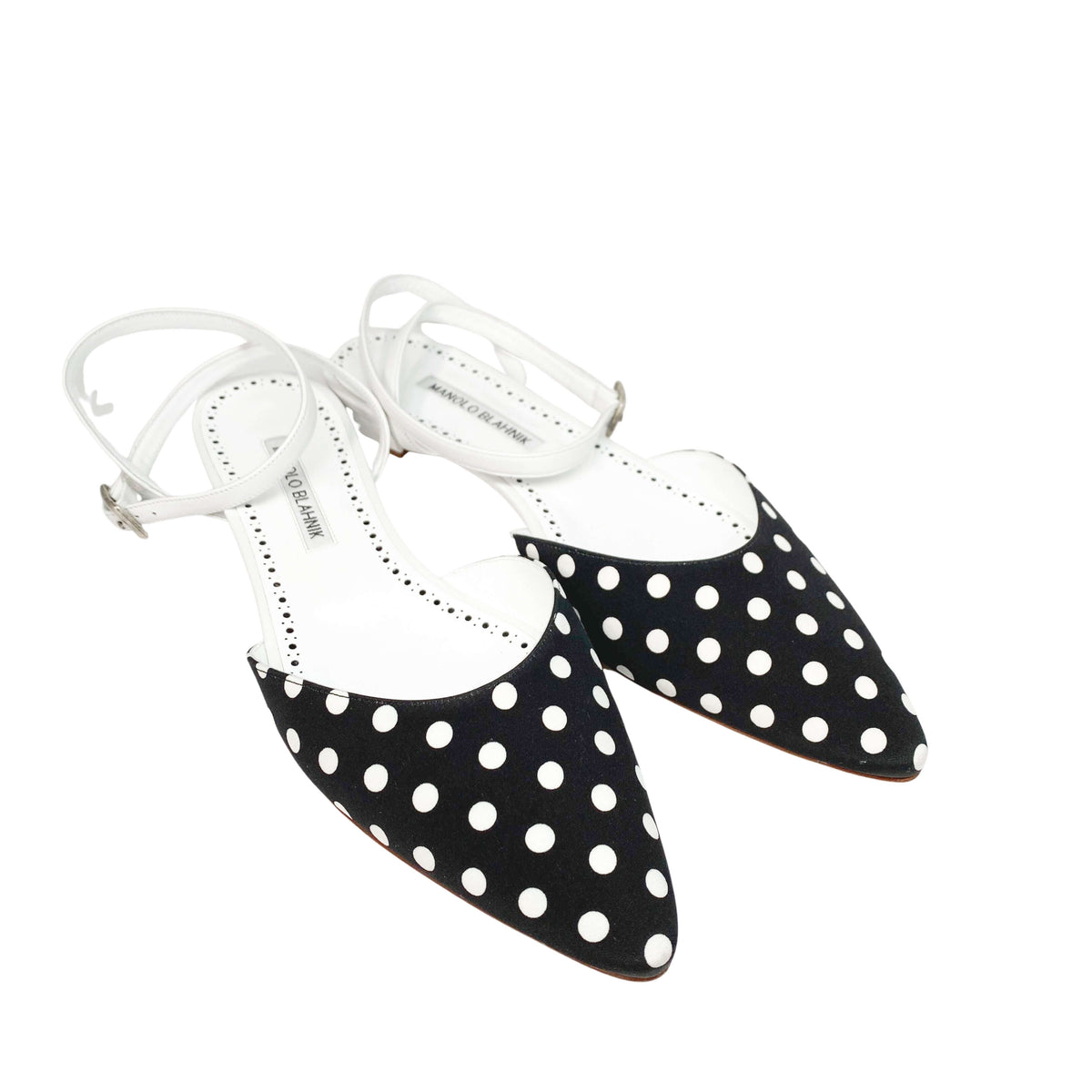 Angled view of the Manolo Blahnik Asenso ankle strap flats showcasing the low half-inch heel and leather trim.
