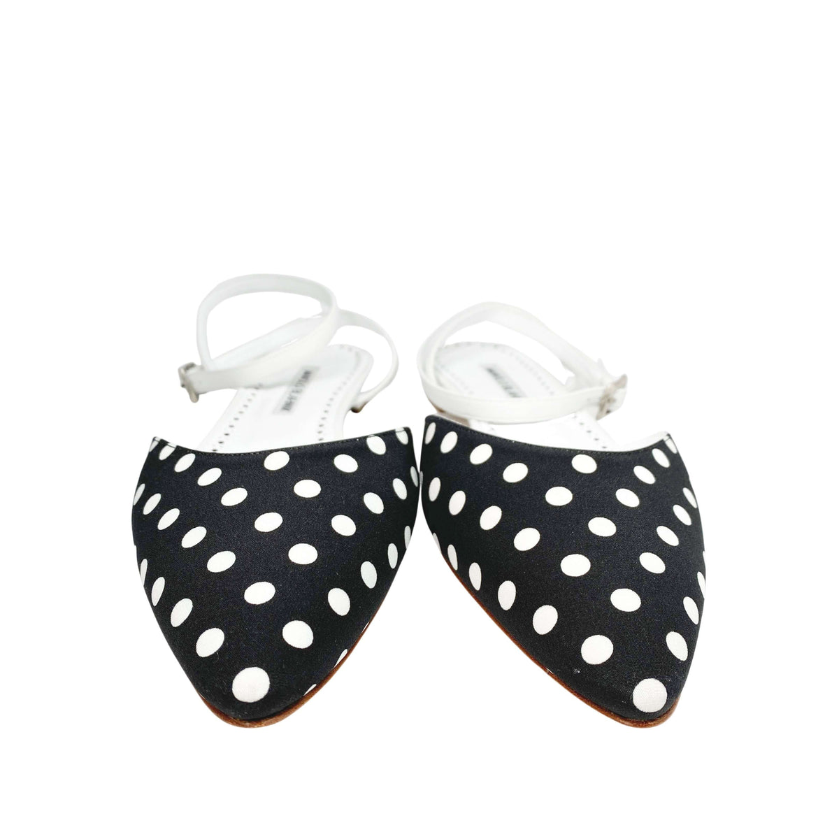 A pair of Manolo Blahnik Asenso polka dot fabric flats highlighting the pointed toe box profile.