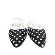 A pair of Manolo Blahnik Asenso polka dot fabric flats highlighting the pointed toe box profile.
