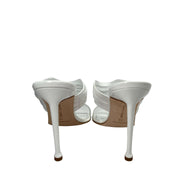 Rear view of a pair of white Manolo Blahnik Curatora sandals highlighting the stiletto heel shape and clean back straps.