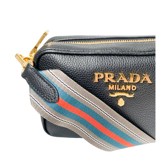 Prada camera bag in black leather with gold hardware and webstrap