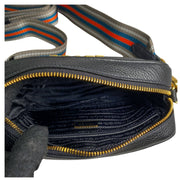 Prada camera bag in black leather with gold hardware and webstrap