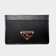 Front view of black Prada card holder in Saffiano leather and nylon featuring iconic triangular enamel logo