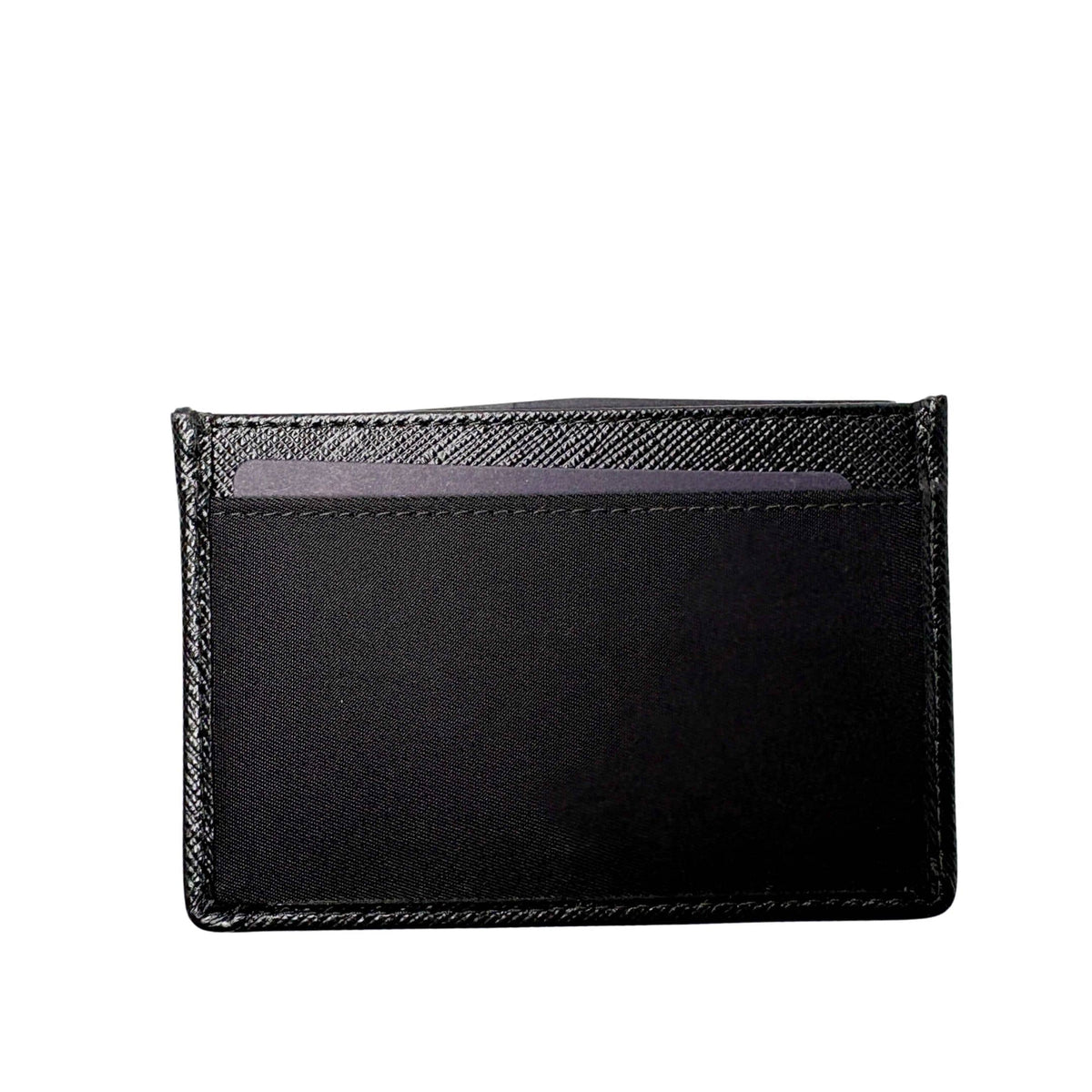 Back view of black Prada Saffiano leather card holder highlighting clean stitching and card slots
