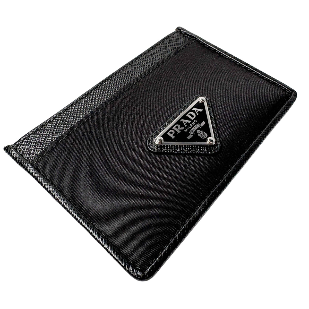 Angled view of black Prada Saffiano leather and nylon card holder showing compact design and slot opening