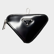 Front view of black Prada Spazzolato leather triangle coin pouch bag charm with iconic enameled metal logo