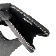 Open view of black Prada Spazzolato triangle coin pouch showing interior compartment and zipper detail