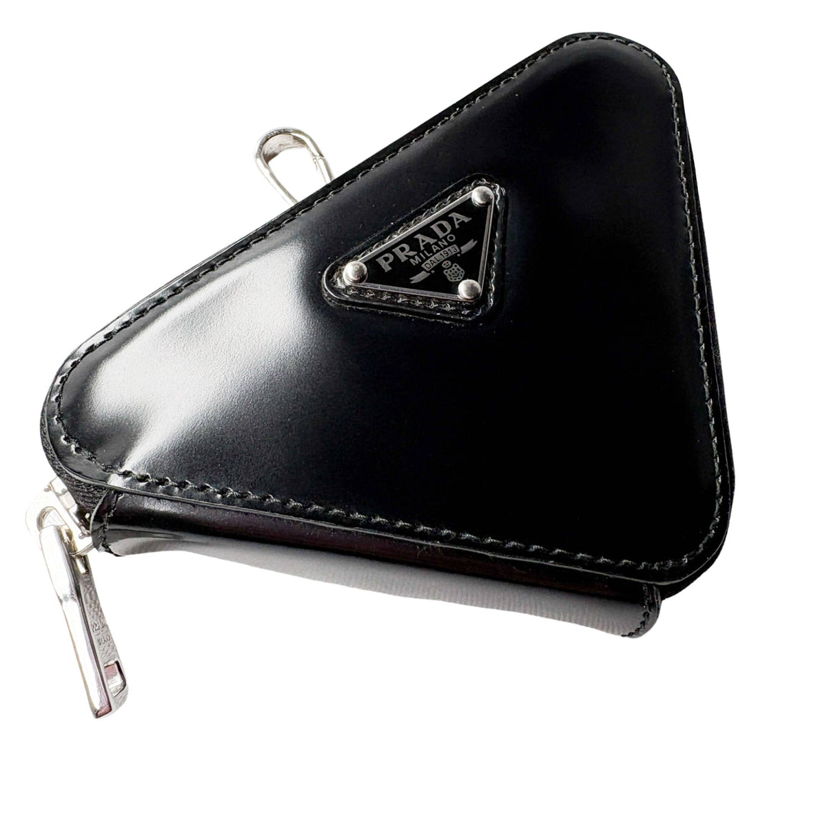 Side profile view of black Prada Spazzolato triangle leather bag charm keyring pouch