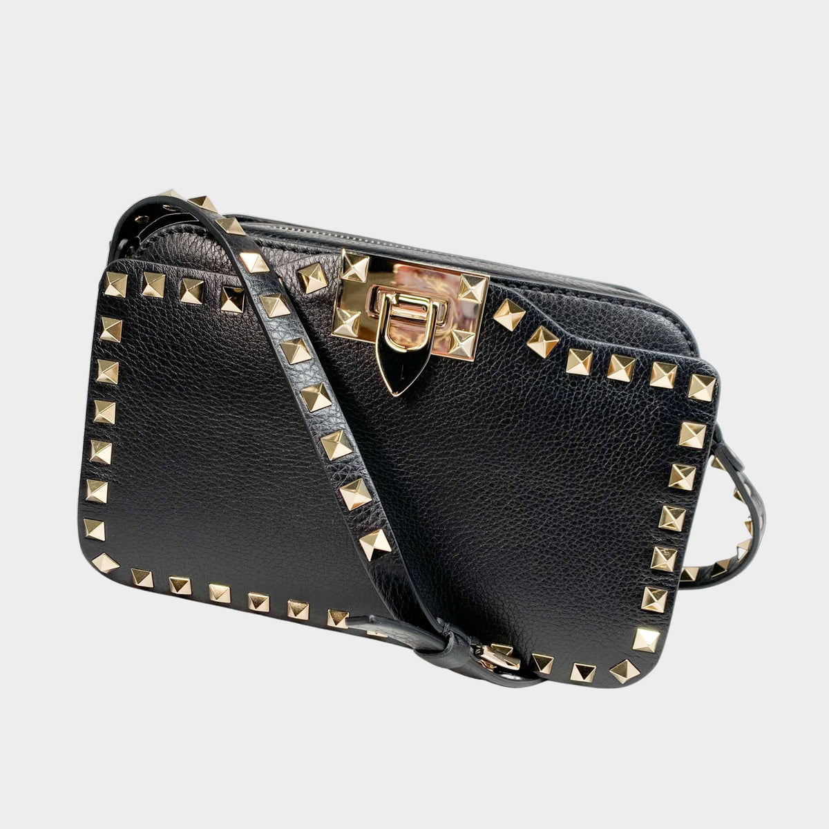 Valentino Rockstud Camera Bag in black leather featuring gold pyramid studs and an adjustable studded strap.