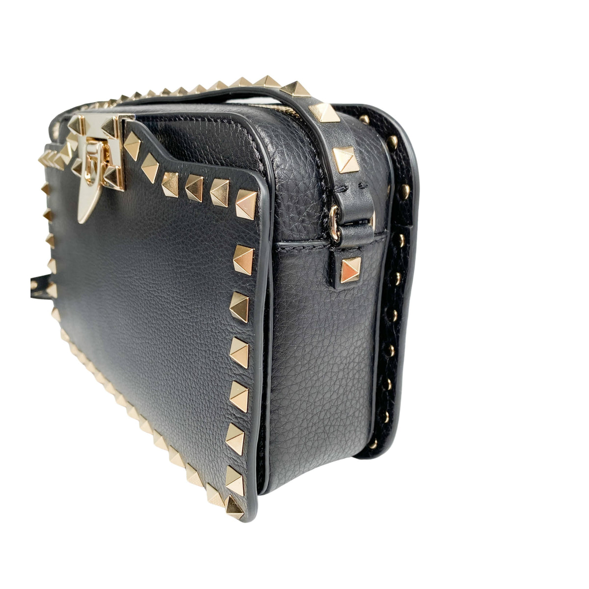 Angled side view of black leather Valentino camera bag showcasing side stud layout and depth.