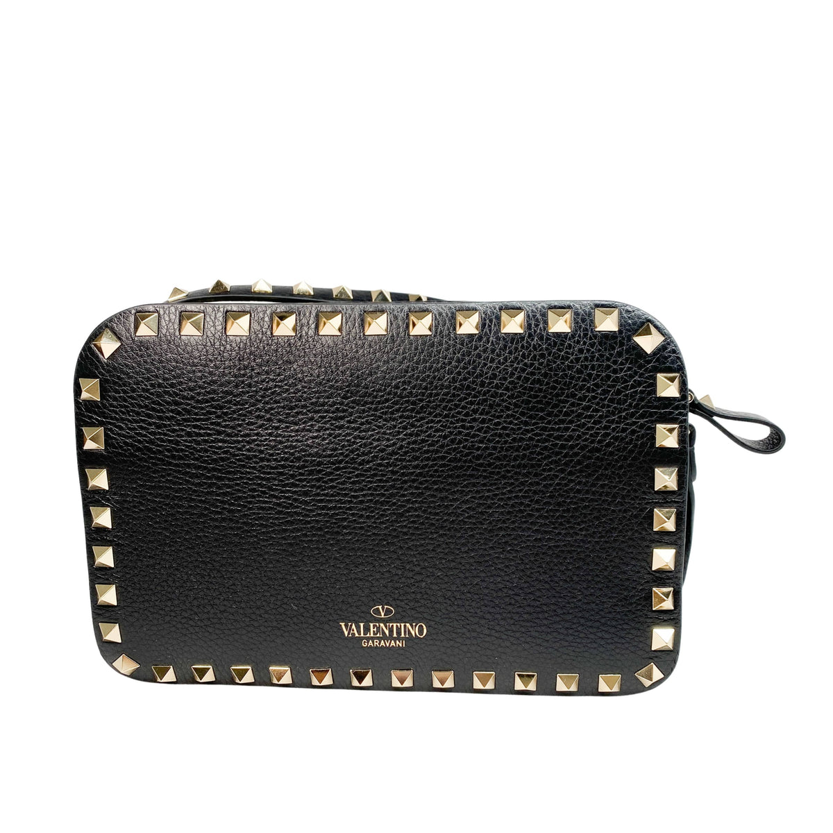 Back view of black leather Valentino Rockstud camera bag showing gold logo stamp and zipper closure.