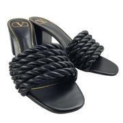 Angled pair view of black leather Valentino rope heel sandals displaying gold footbed logo and block heel.