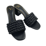 Front-angled view of Valentino black leather sandals showcasing the intricate braided rope design.