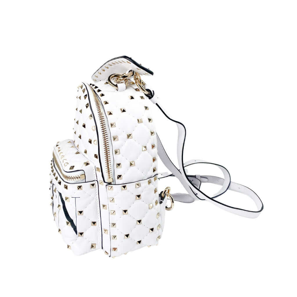 Angled side view of white quilted leather Valentino Rockstud backpack showing side compartment depth and straps.